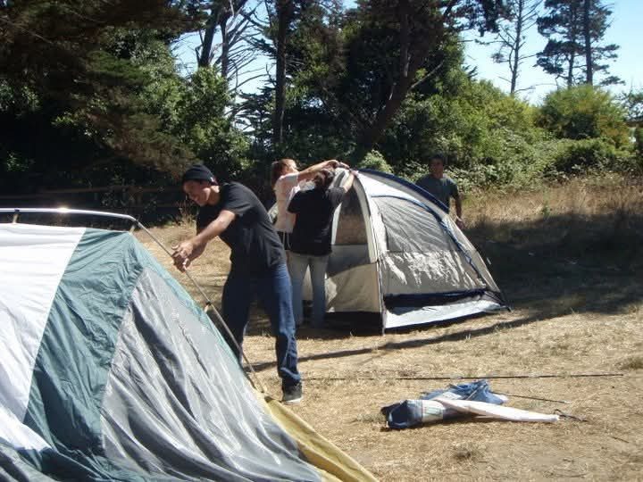Youth setting up tents on a camping trip